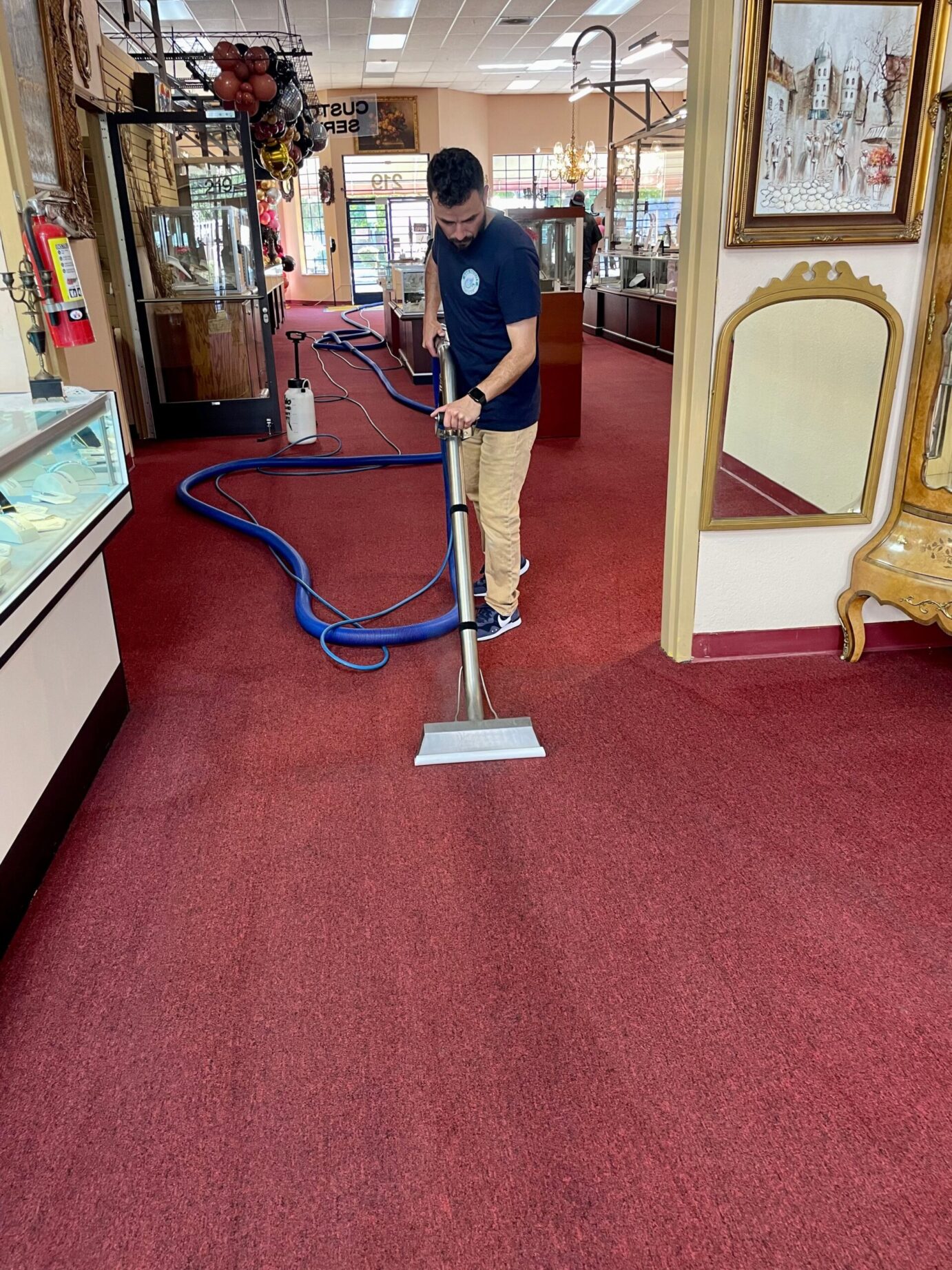 A&G Facility Services employee cleaning a carpet at a store in Monterey, California.