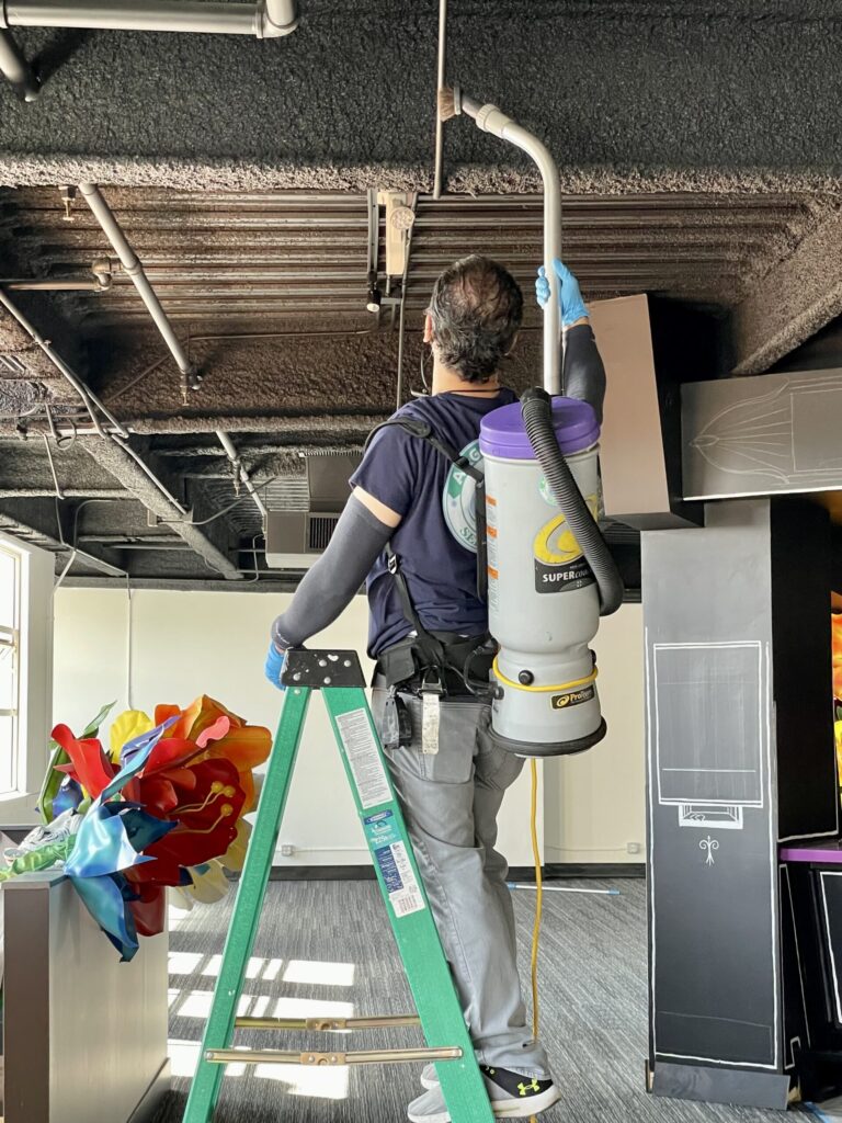 Professional dusting of office surfaces at a business