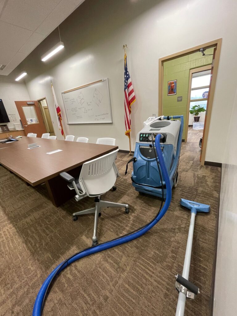 Steam carpet cleaning equipment in action.