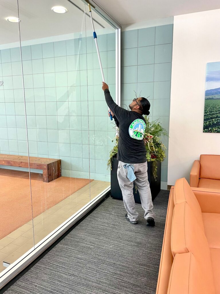 Professional window cleaners using equipment in Monterey